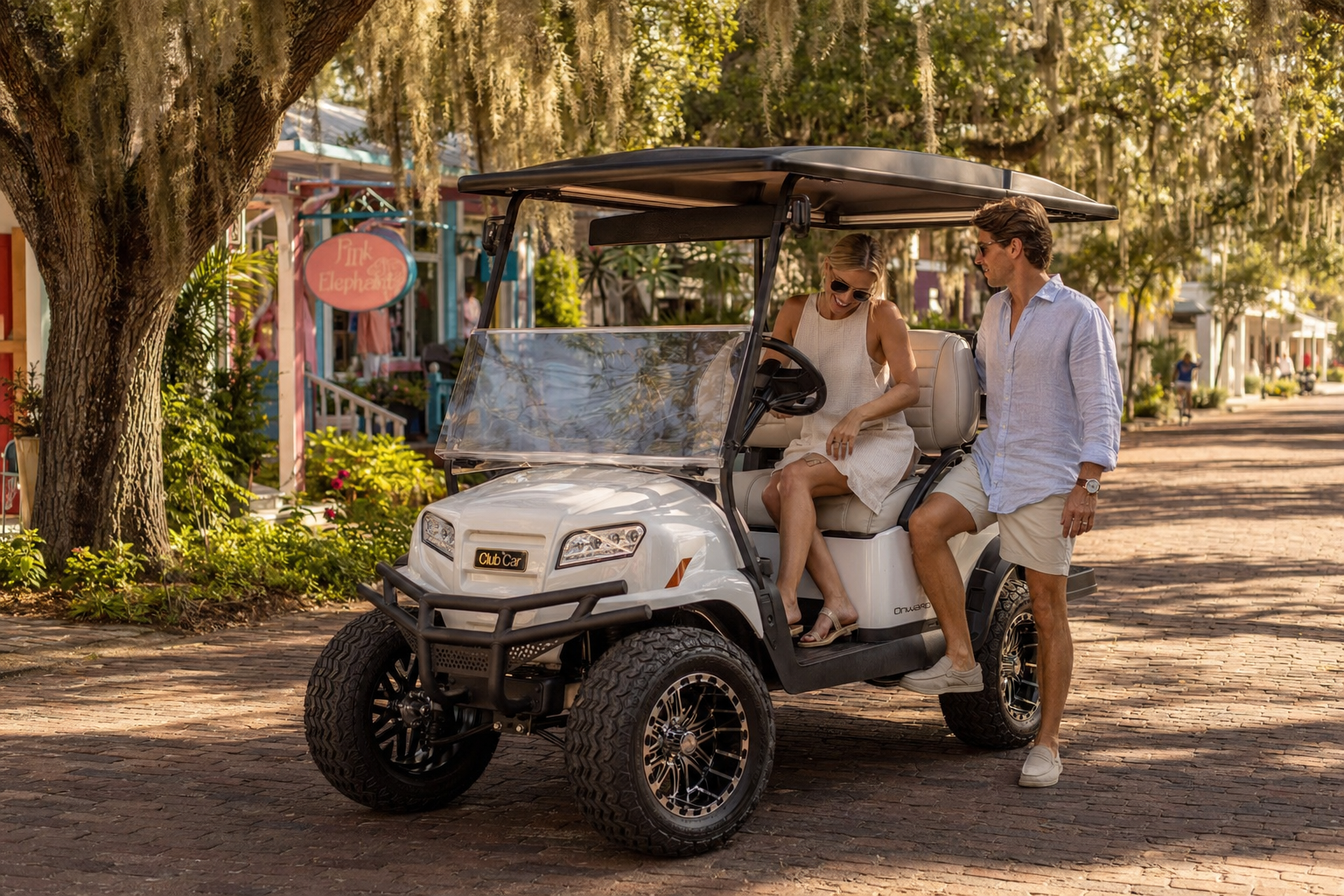 Late-model Club Car Onward golf cart on a palm-lined street in Boca Grande